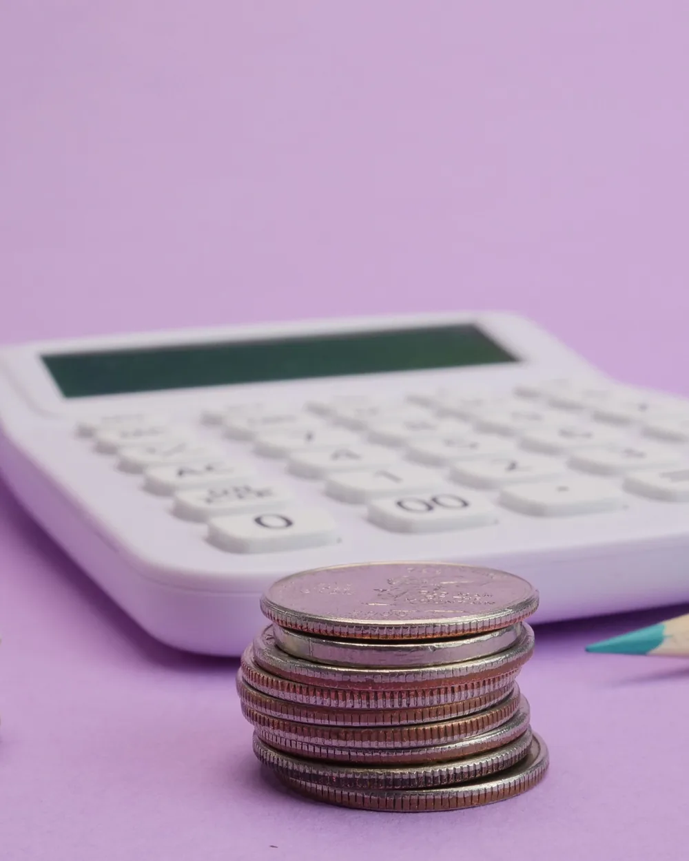 Calculator, coins, and stationery arranged for financial planning