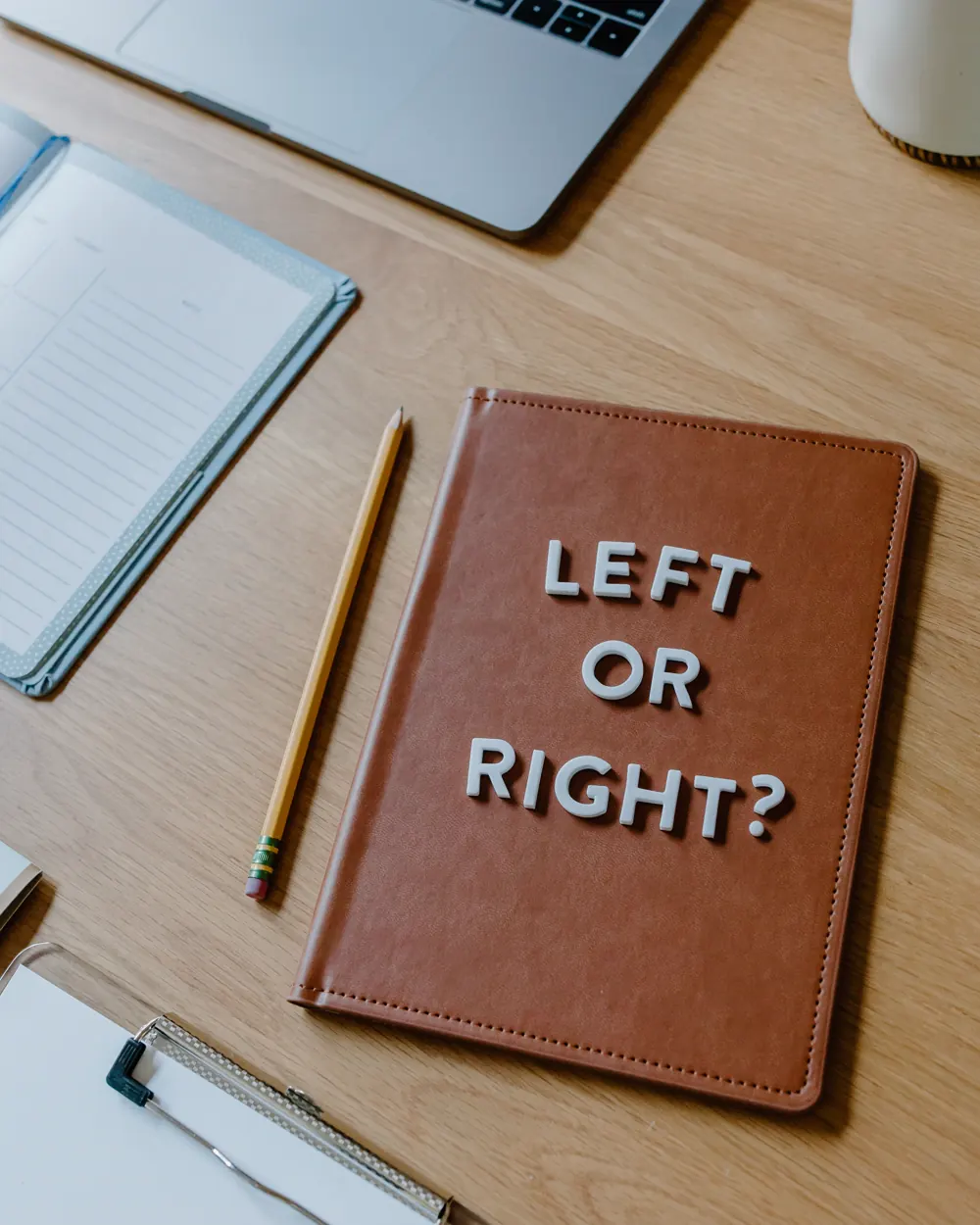 Notebook asking left or right beside organized work materials