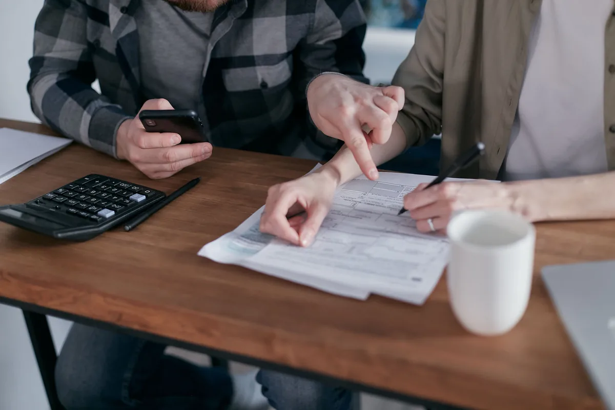 Couple reviewing financial papers together at a table
